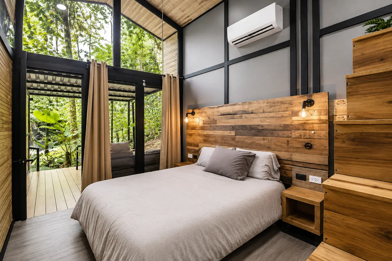Palm Jungalow bedroom with queen bed facing the glass doors onto the jungle deck in Ojochal, Costa Rica