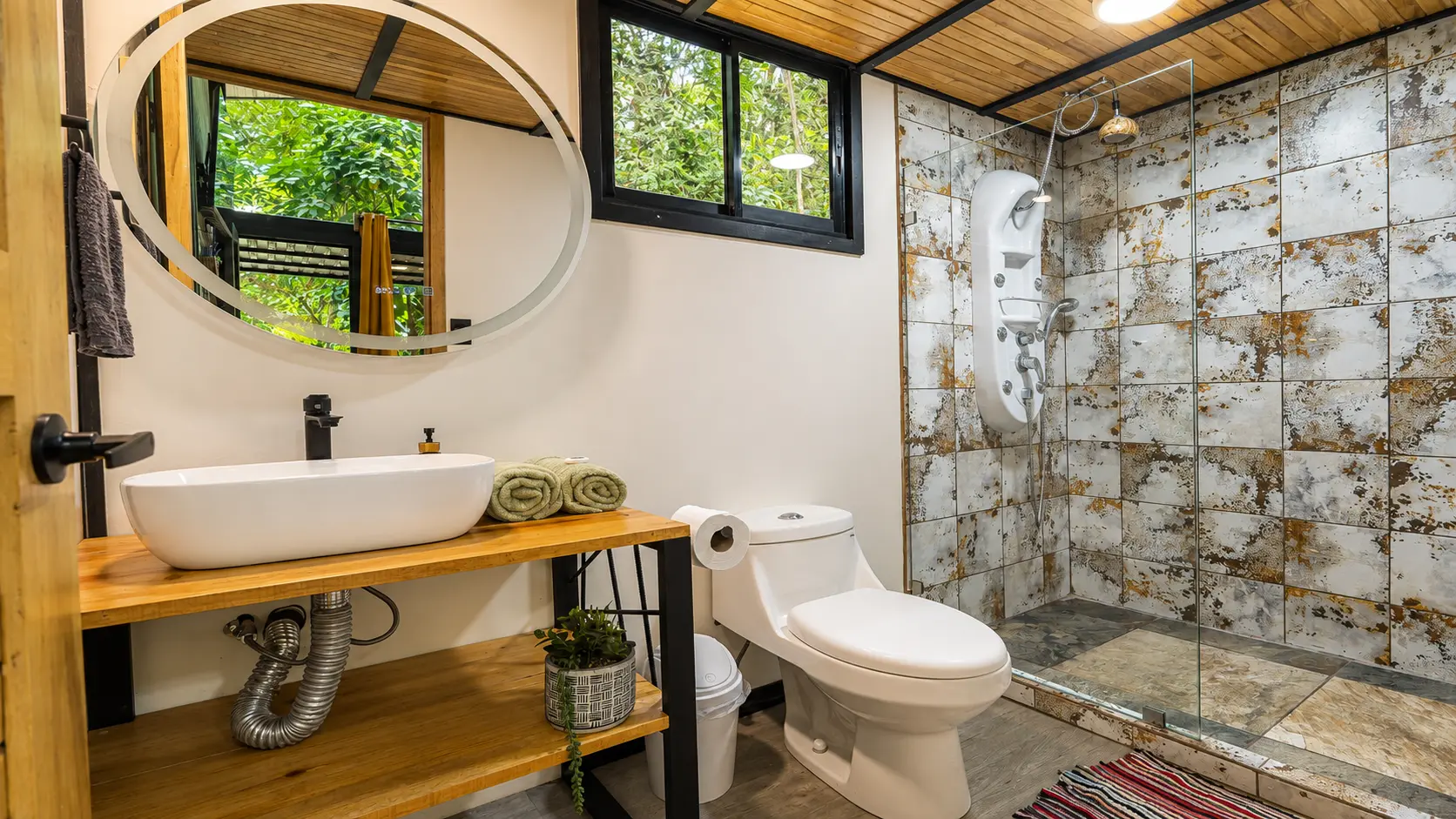 Pebble Jungalow bathroom with vessel sink and walk-in shower