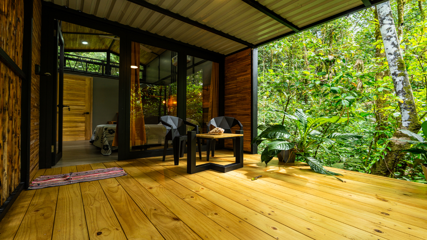 Pebble Jungalow deck looking into the jungle canopy in Ojochal, Costa Rica