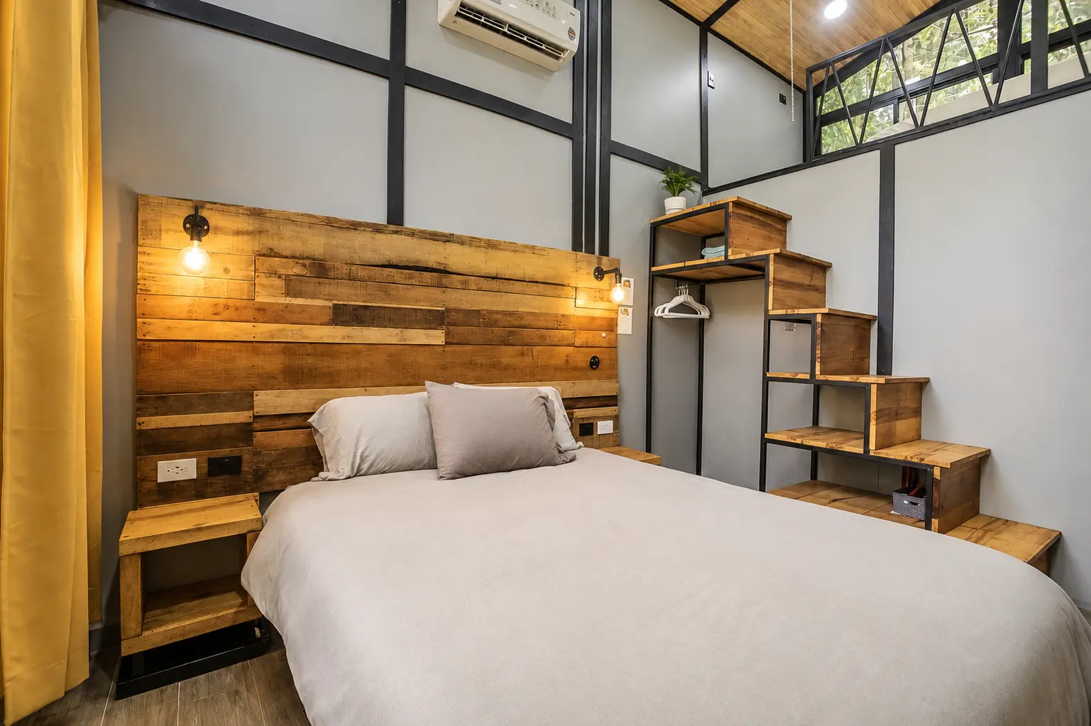 Queen bed with reclaimed-wood headboard in The Palm Jungalow, Ojochal Costa Rica