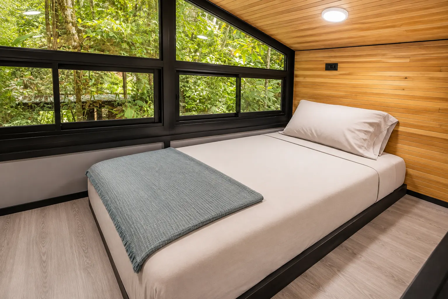 Loft bed with jungle windows in The Pebble Jungalow