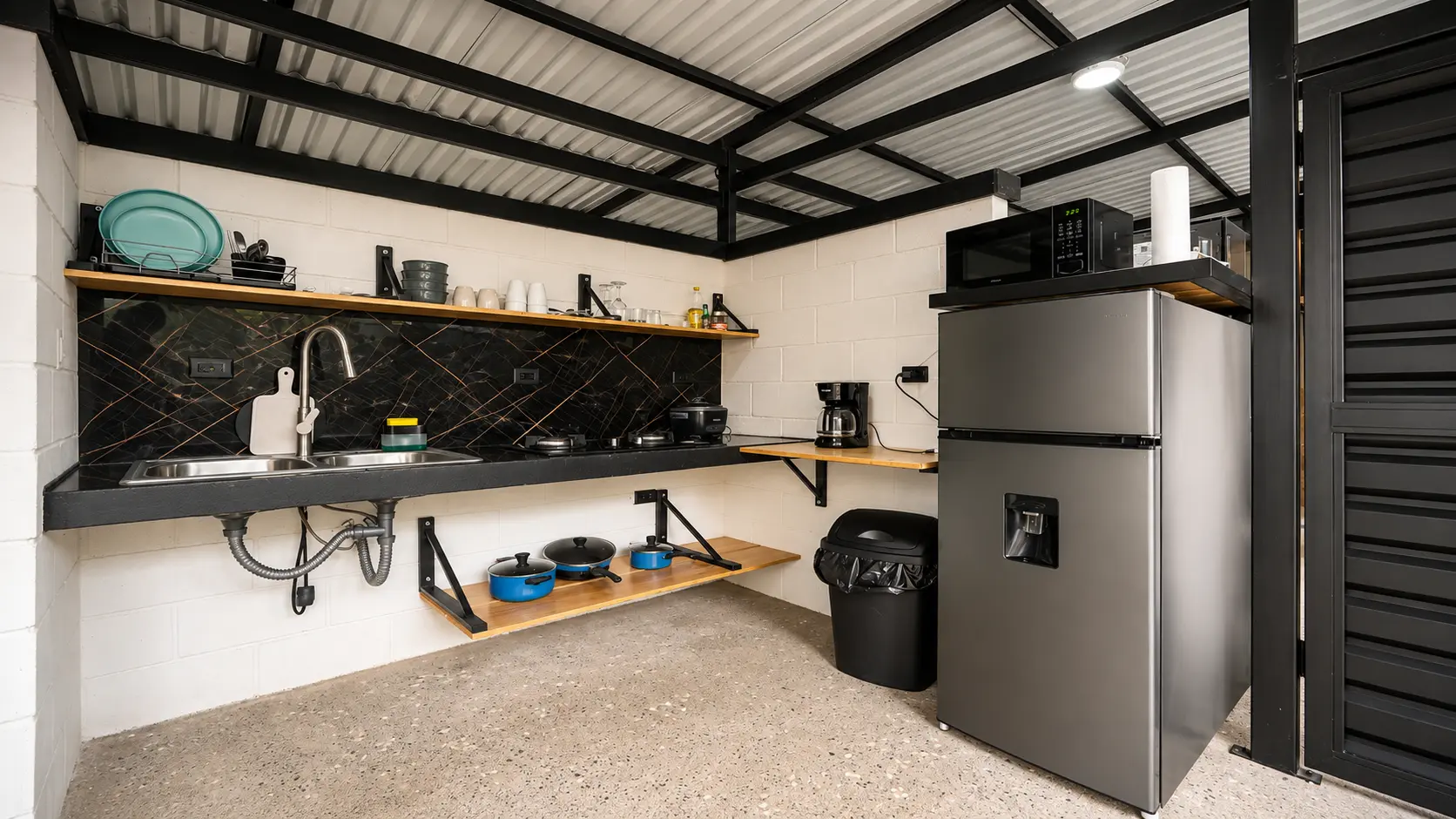 Outdoor kitchen at The Palm Jungalow with fridge, cooktop and coffee maker